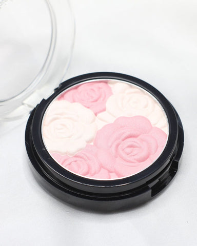 Open round blush compact with pink and pale flower-shaped powder design