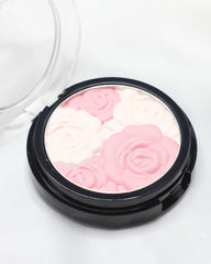 Open round blush compact with pink and pale flower-shaped powder design