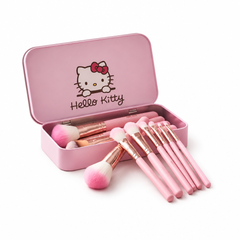 Pink makeup brushes with open Hello Kitty-themed pink storage tin on white background