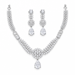 Silver-tone floral necklace with matching teardrop earrings on a white background