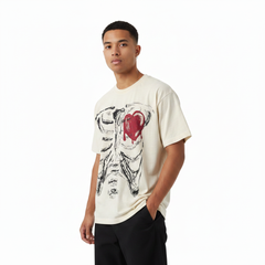 Stylish male model wearing a cream T-shirt with ribcage and red melted-heart graphic