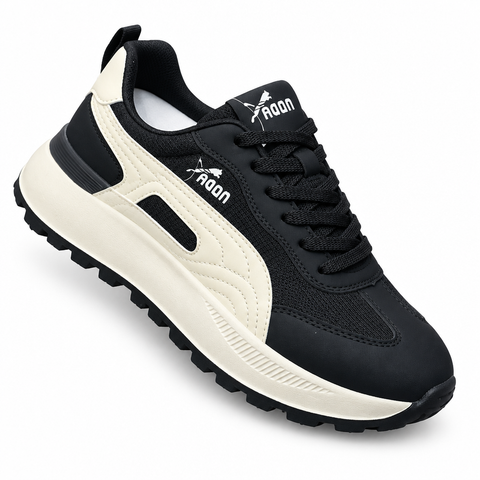 Black sneaker with cream accents on white background