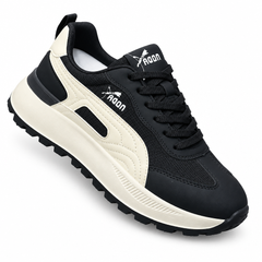 Black sneaker with cream accents on white background
